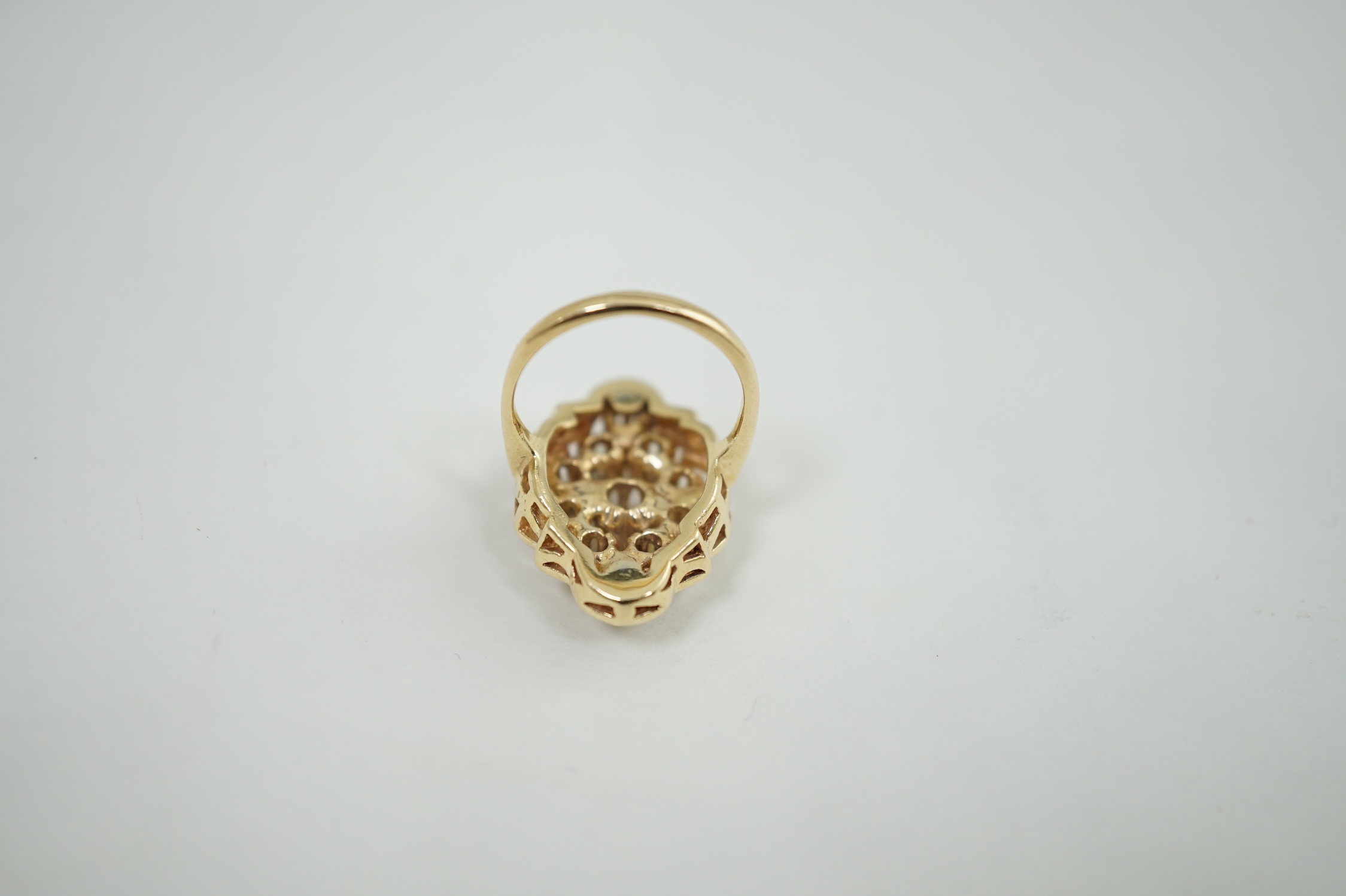 A modern gold and diamond cluster set ring